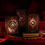 On a red fabric background sits the three journals for the Serpents & Swords collection- the journal, reading journal and reading companion. Sitting on a gold tray, the journals are all black and feature intricate red and gold foiling that show motifs of snakes, swords, dragons, crowns, goblets and more from a romantasy book aesthetic.