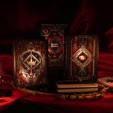 On a red fabric background sits the three journals for the Serpents & Swords collection- the journal, reading journal and reading companion. Sitting on a gold tray, the journals are all black and feature intricate red and gold foiling that show motifs of snakes, swords, dragons, crowns, goblets and more from a romantasy book aesthetic.
