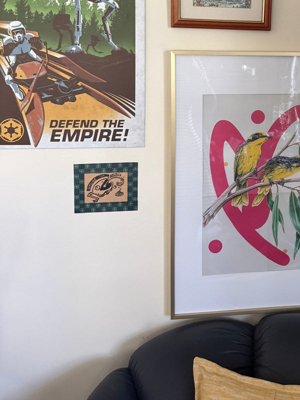 Classic green washi tape is used to hand a small illustration up on a wall