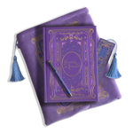 The wisteria reading journal bundle from the classic book inspired Literati collection. This soft lilac variation includes a book sleeve, reading journal, pen and bookmark from the collection. All share a slightly Victorian book inspired motif in shades of gold, pink, purple and blue. The foiled reading journal, pen and bookmark feature intricate gold foiling while the velvet book sleeve is embroidered. The sleeve and bookmark also feature light blue tassels.