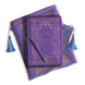 The wisteria reading journal bundle from the classic book inspired Literati collection. This soft lilac variation includes a book sleeve, reading journal, pen and bookmark from the collection. All share a slightly Victorian book inspired motif in shades of gold, pink, purple and blue. The foiled reading journal, pen and bookmark feature intricate gold foiling while the velvet book sleeve is embroidered. The sleeve and bookmark also feature light blue tassels.