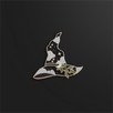 A pin shaped like a black witch's hat with gold accents and a small branch of leaves sits on a black background