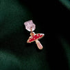 toadstool mushroom charm attached to a USB-C plastic dust plug to protect your charging port. Accessory sits against a green background