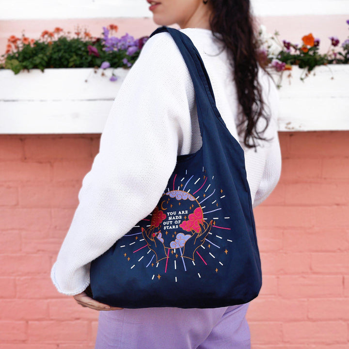 Navy Cotton Reusable Shopping tote bag. Colourful and gold moon and stars stitching embroidery. Eco friendly cotton bag, crystal ball design with 'You Are Made of Stars' text. 